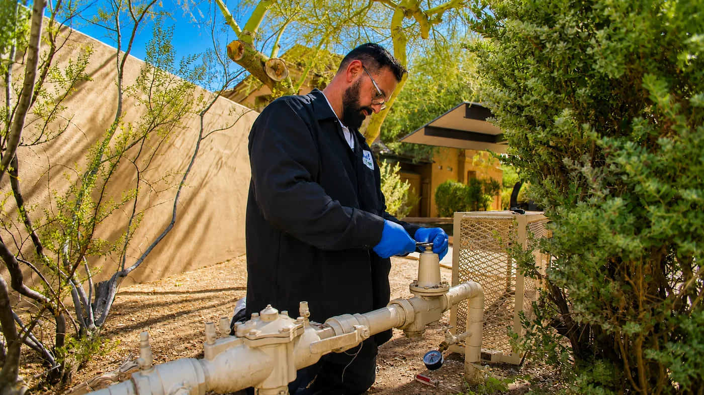 Technician servicing an outdoor gas line