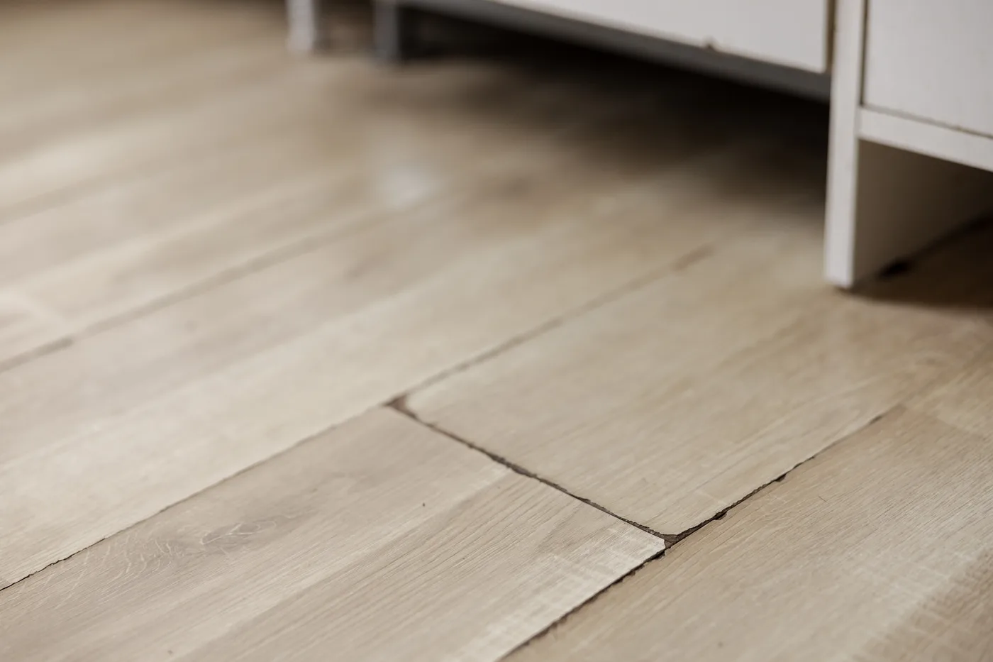 Wood plank floor buckling from a slab leak